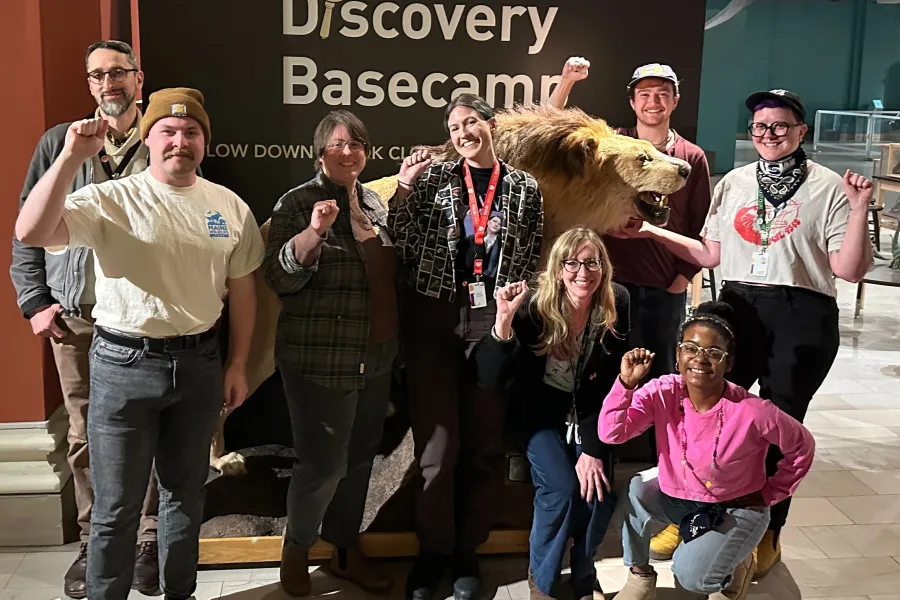 The Bargaining Committee in front of a taxidermized lion in the Carnegie Museum of Natural History.