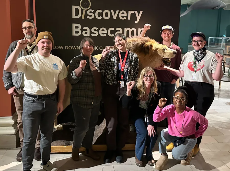 The Bargaining Committee in front of a taxidermized lion in the Carnegie Museum of Natural History.